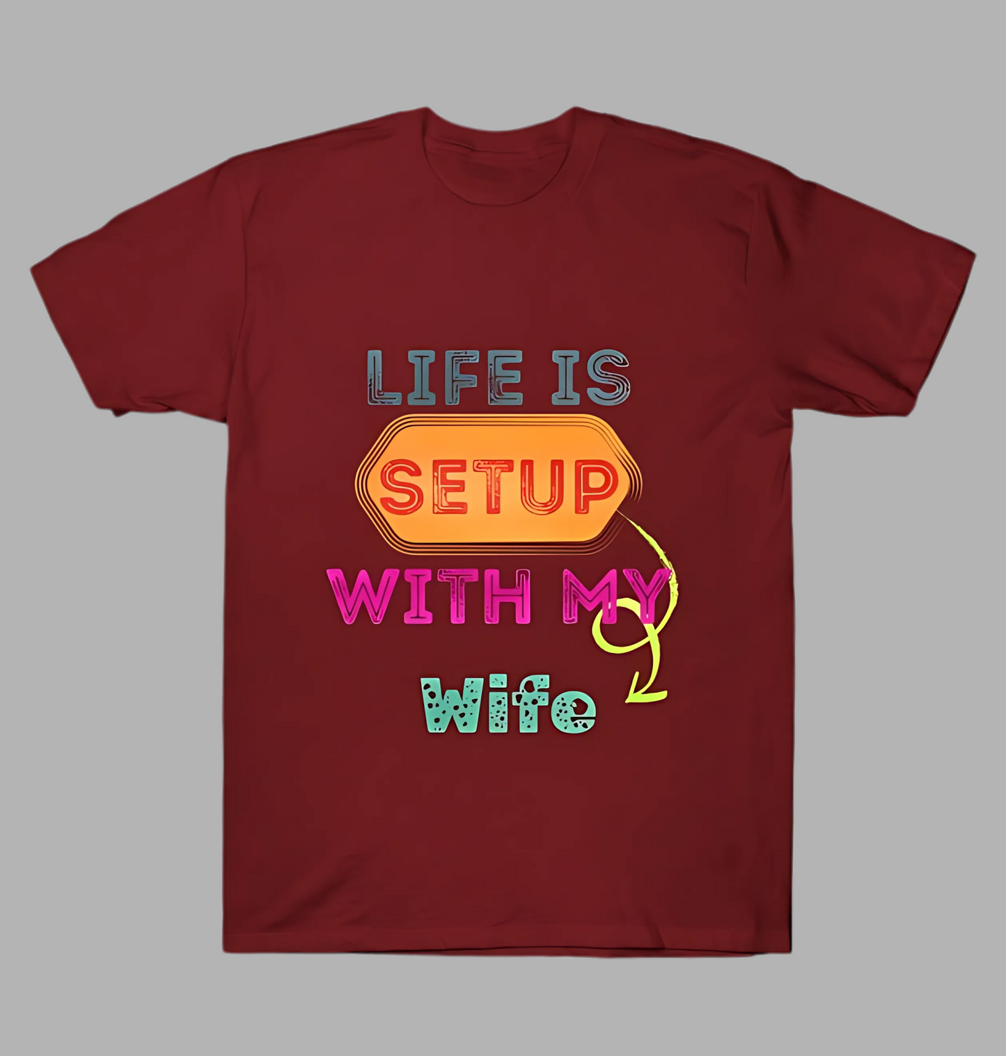 Maroon t-shirt with colorful text design on a gray background